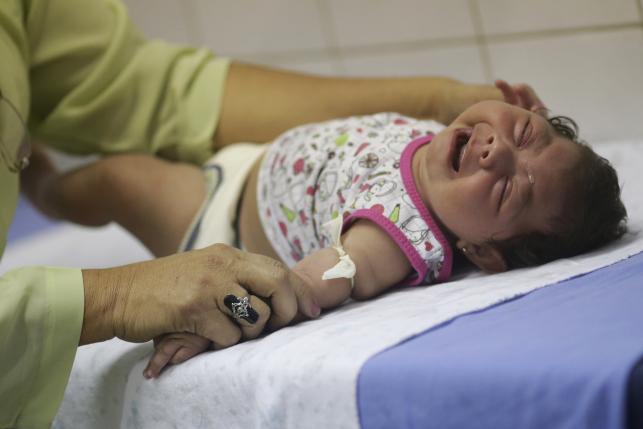 Hospital staff Oswaldo Cruz prepares to draw blood from baby Lorrany Emily da Silva, who has microcephaly, at the Oswaldo Cruz Hospital in Recife, Brazil, January 26, 2016. REUTERS/Ueslei Marcelino